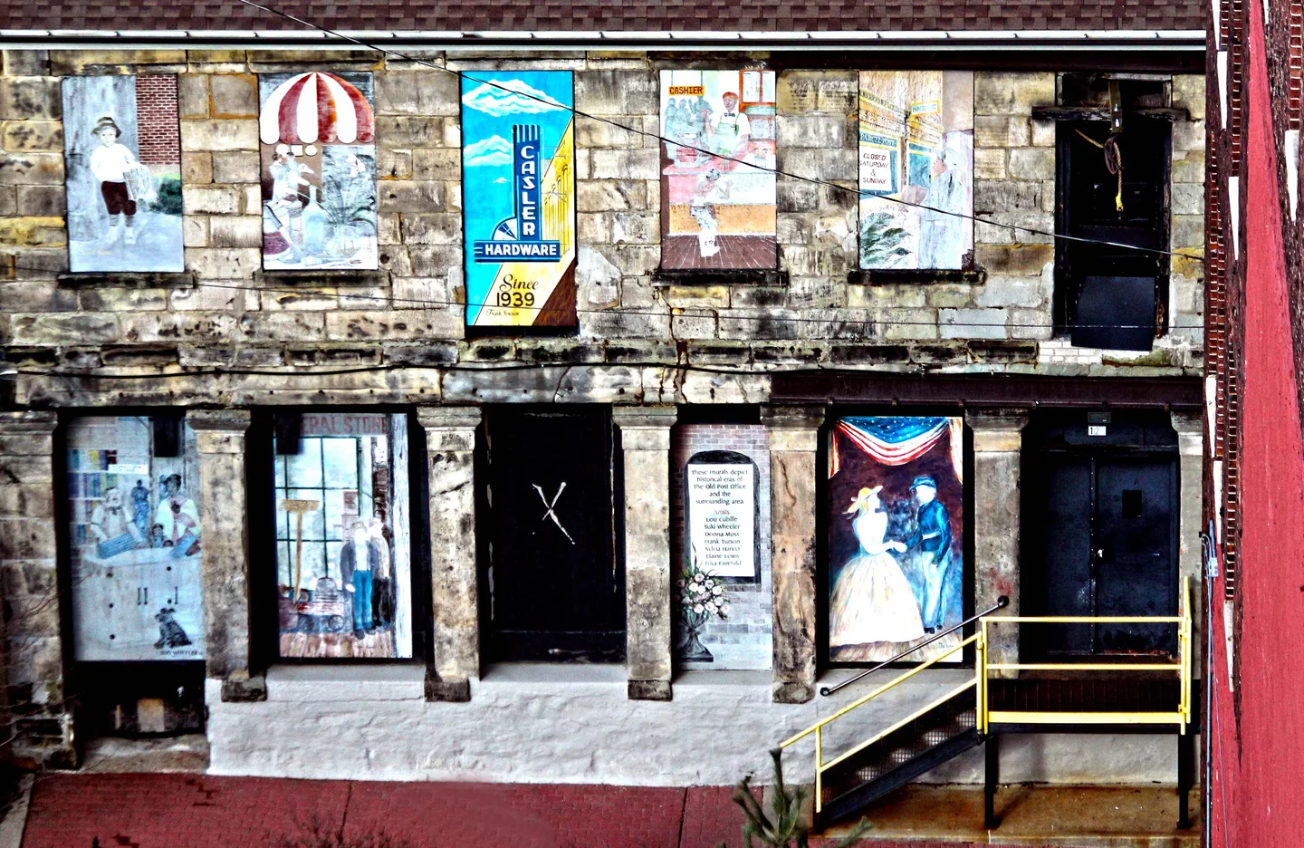 Weathered brick and stone wall with colorful murals